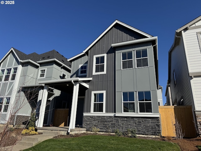 view of front of house featuring stone siding and board and batten siding