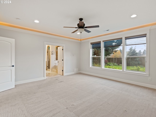 empty room featuring ceiling fan and light colored carpet