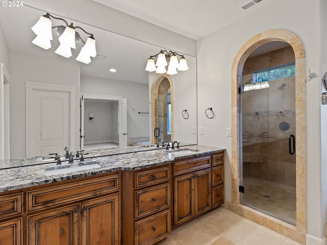 bathroom featuring vanity, tile patterned floors, and a shower with shower door