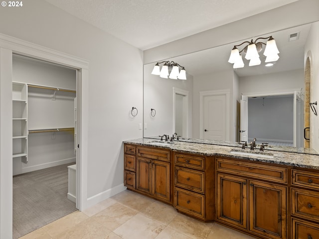 bathroom with vanity and a textured ceiling