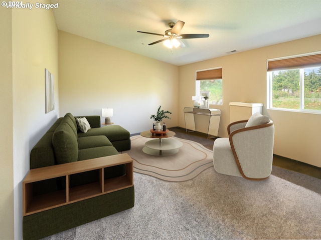 carpeted living room with ceiling fan