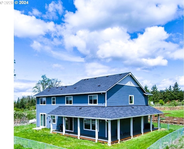 back of property featuring a shingled roof and a porch