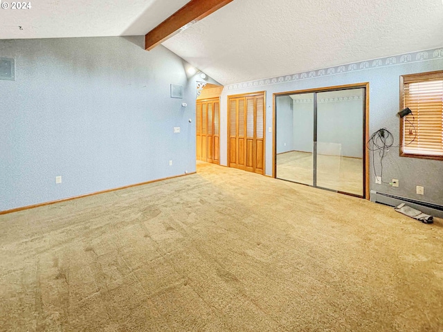 carpeted empty room with vaulted ceiling with beams, a baseboard heating unit, and a textured ceiling