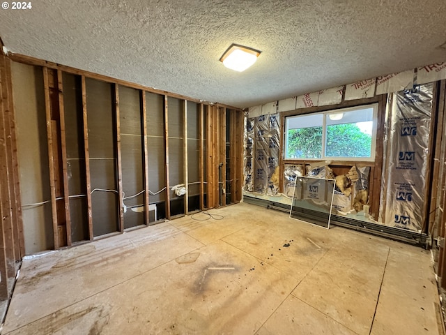 miscellaneous room with a textured ceiling