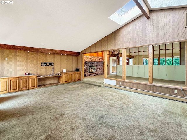 unfurnished living room featuring vaulted ceiling with beams, a fireplace, and carpet