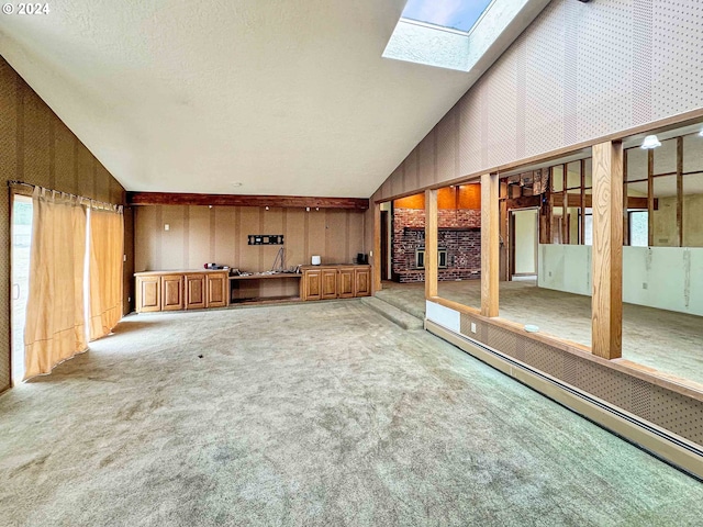 interior space featuring baseboard heating and vaulted ceiling with skylight