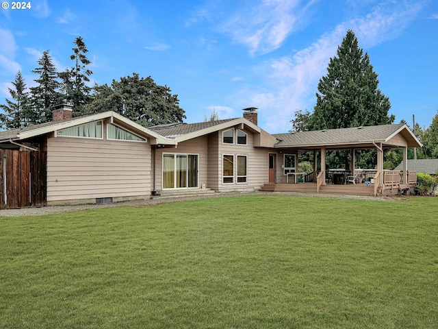 rear view of property featuring a yard