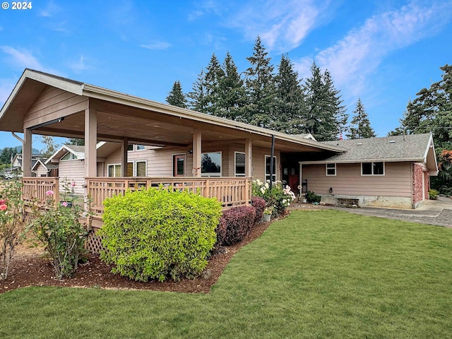 view of front of property with a front yard and a deck