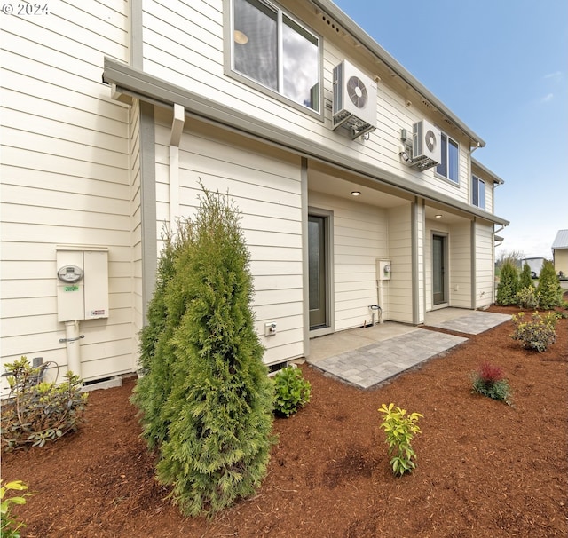 back of house with ac unit and a patio area