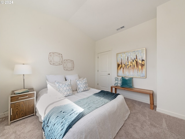 carpeted bedroom featuring vaulted ceiling