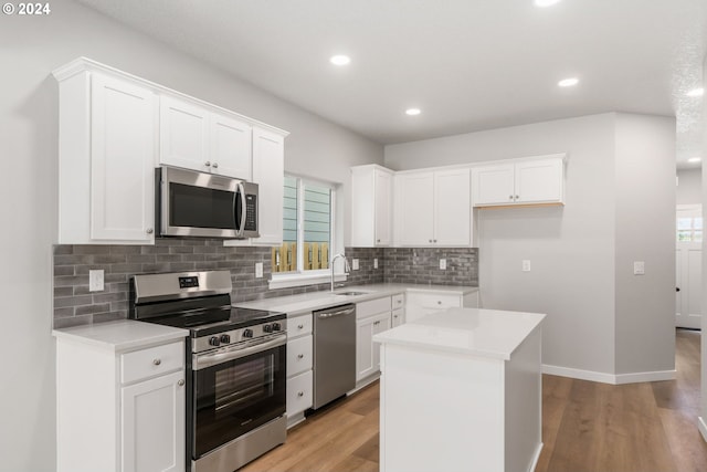 kitchen featuring white cabinets, a center island, and appliances with stainless steel finishes