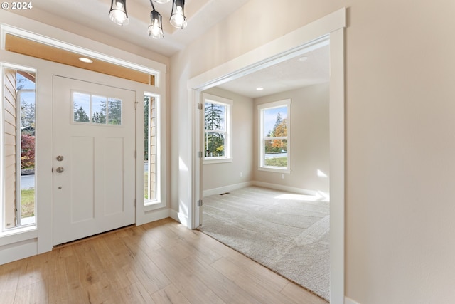 entryway featuring light hardwood / wood-style flooring and a notable chandelier