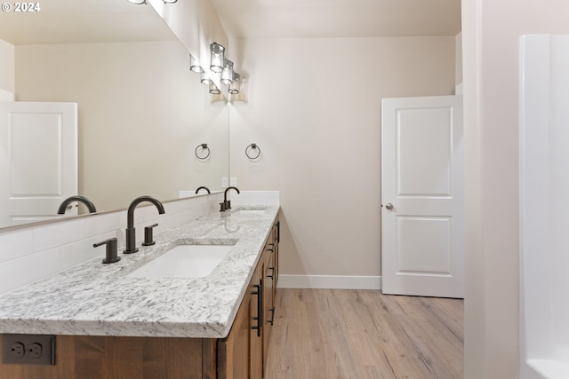 bathroom featuring hardwood / wood-style flooring and vanity