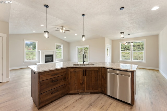 kitchen with dishwasher, an island with sink, light hardwood / wood-style flooring, and sink