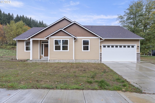 view of front of property featuring a garage and a front lawn