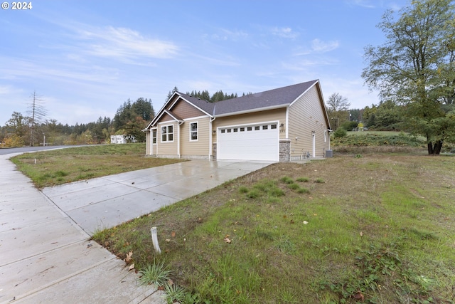 view of front of home featuring a garage and a front lawn