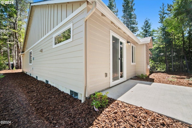 view of side of property with a patio