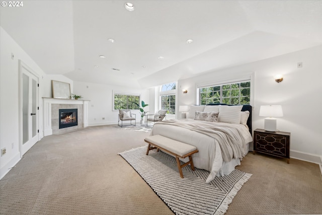 6145 SW Sweetbriar Ct, Portland, OR 97221 - bedroom with light carpet, vaulted ceiling, a tiled fireplace, and baseboards
