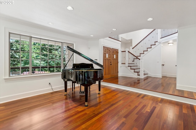 living area with baseboards, stairway, wood finished floors, and recessed lighting