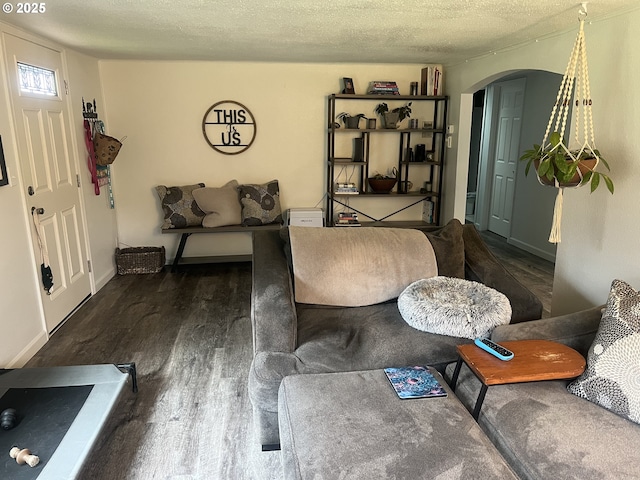 living room featuring dark hardwood / wood-style floors and a textured ceiling