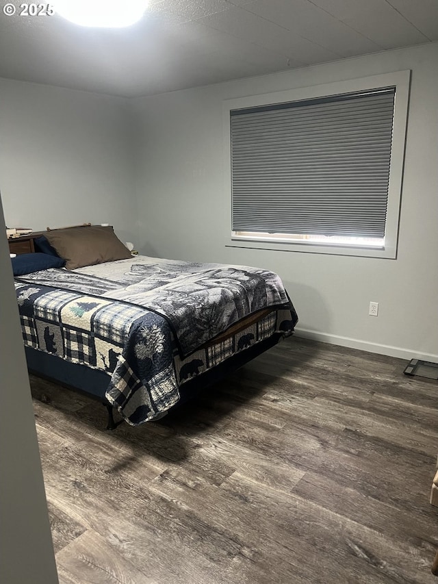 bedroom with dark hardwood / wood-style flooring