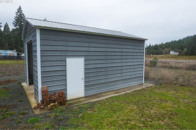 view of outbuilding featuring a yard