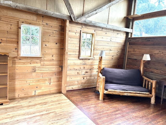 sitting room featuring a wealth of natural light, hardwood / wood-style floors, and wood walls