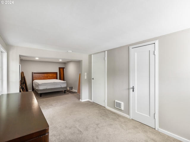 unfurnished bedroom featuring light carpet