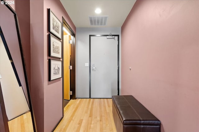 hallway with light hardwood / wood-style floors