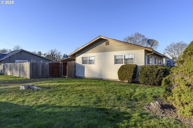 view of side of property with a yard