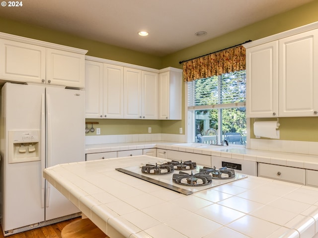 15337 SE Olds Dr, Clackamas, OR 97015 - kitchen featuring white appliances, tile counters, recessed lighting, white cabinets, and a sink