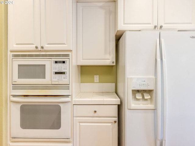 15337 SE Olds Dr, Clackamas, OR 97015 - kitchen featuring white appliances, tile countertops, and white cabinetry