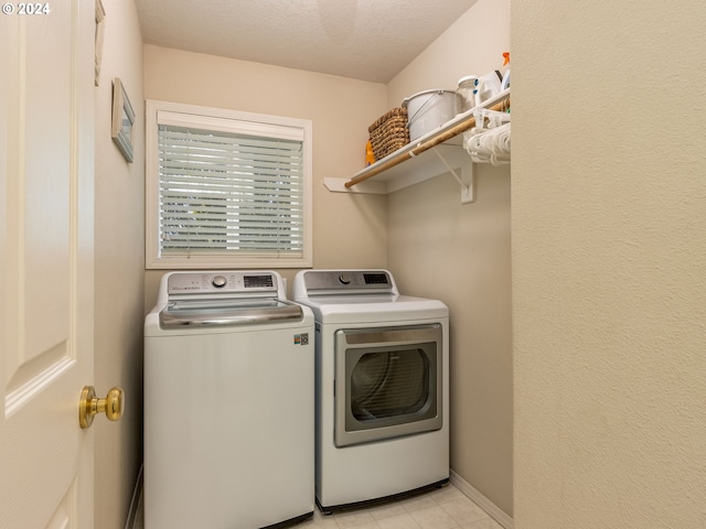 15337 SE Olds Dr, Clackamas, OR 97015 - washroom featuring washer and clothes dryer, a textured ceiling, light tile patterned floors, and baseboards
