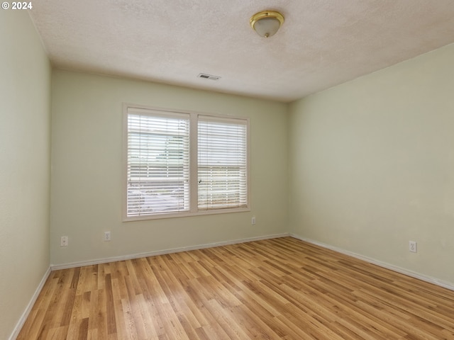 15337 SE Olds Dr, Clackamas, OR 97015 - empty room featuring light wood finished floors, baseboards, and a textured ceiling