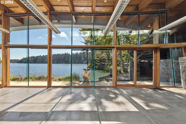 unfurnished sunroom with a water view and a wealth of natural light
