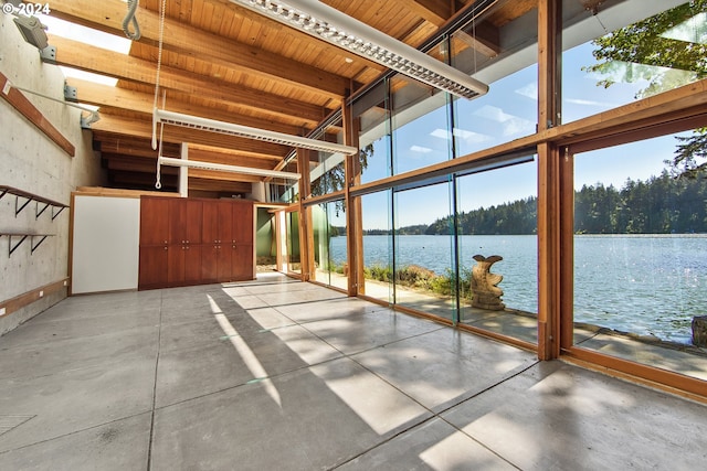 unfurnished sunroom with a water view