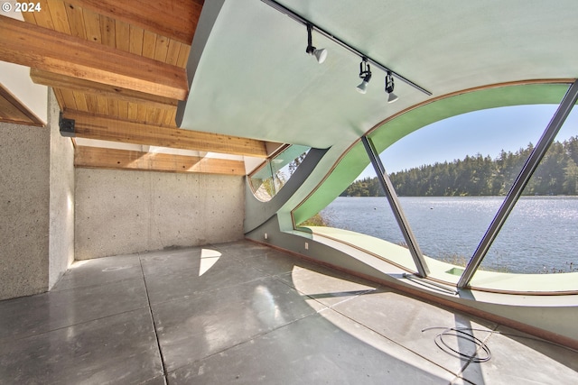 unfurnished sunroom with rail lighting and a water view