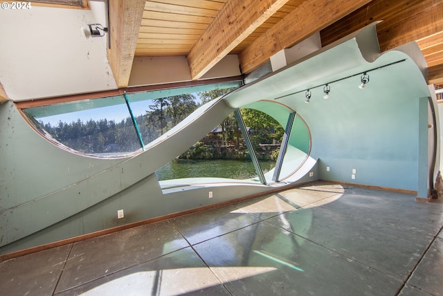 interior details featuring wooden ceiling, beam ceiling, and concrete floors