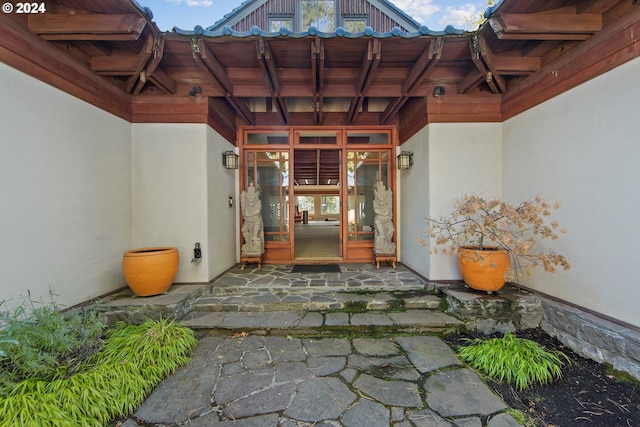 view of exterior entry with a patio area and french doors