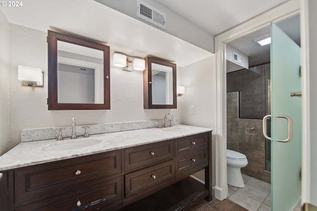 full bathroom featuring toilet, a sink, and visible vents