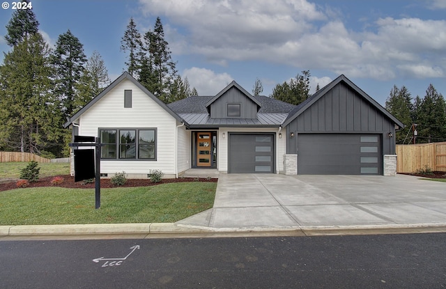 modern farmhouse style home featuring a garage and a front yard