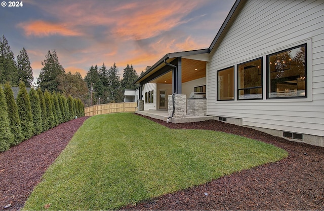 yard at dusk with a patio