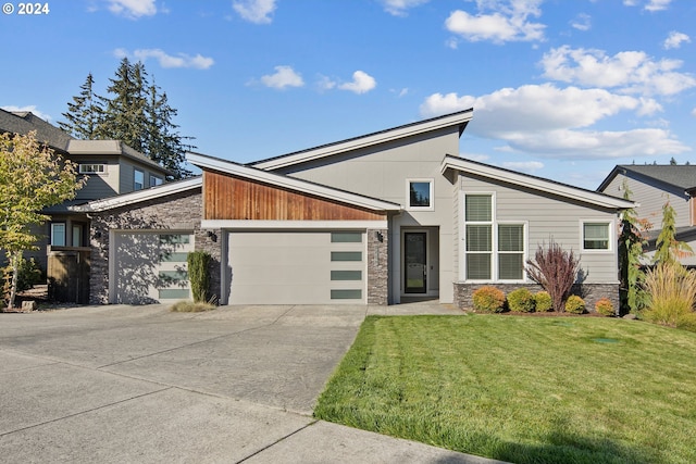 contemporary home with a front lawn and a garage