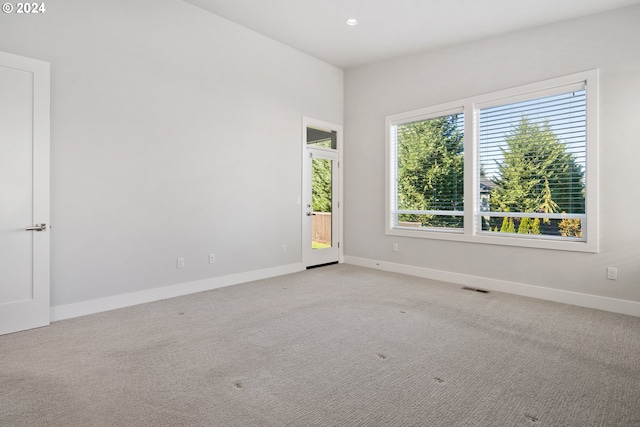 unfurnished room with light carpet