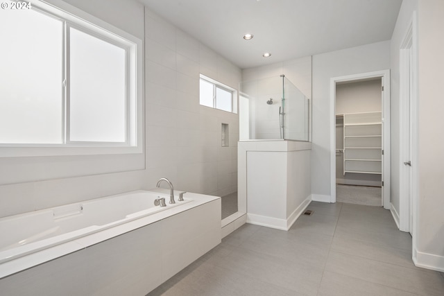 bathroom with tile patterned flooring and plus walk in shower