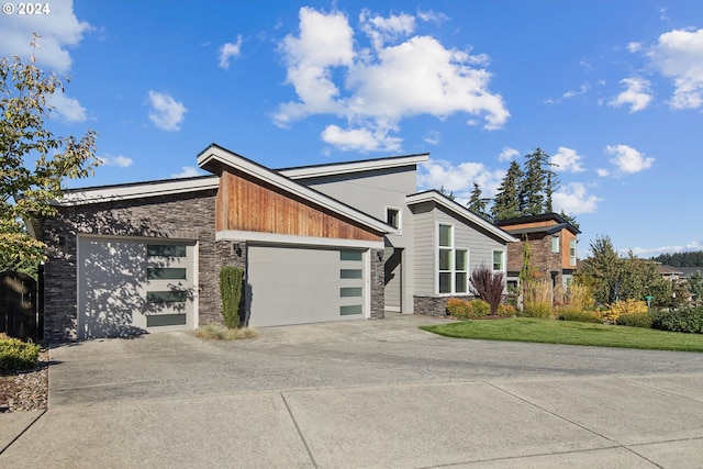 view of front of property with a front yard and a garage