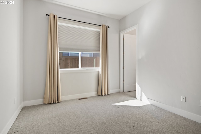 empty room with light colored carpet