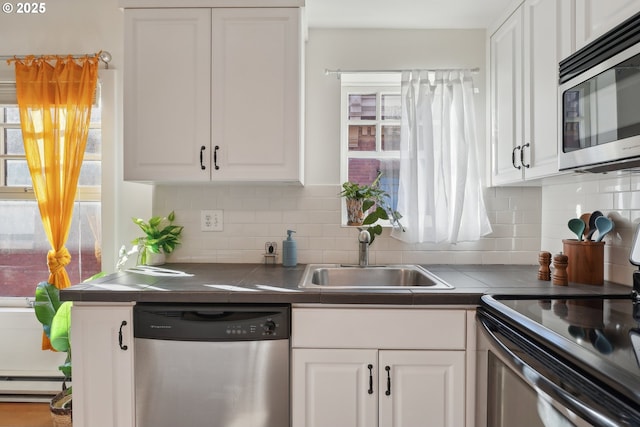 kitchen with sink, white cabinets, and stainless steel appliances