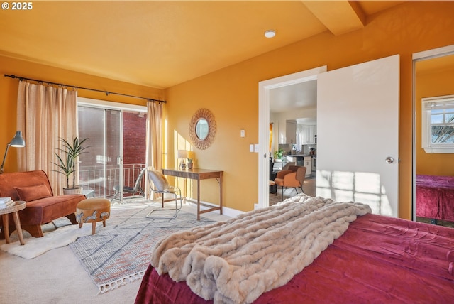 carpeted bedroom featuring access to exterior and beamed ceiling