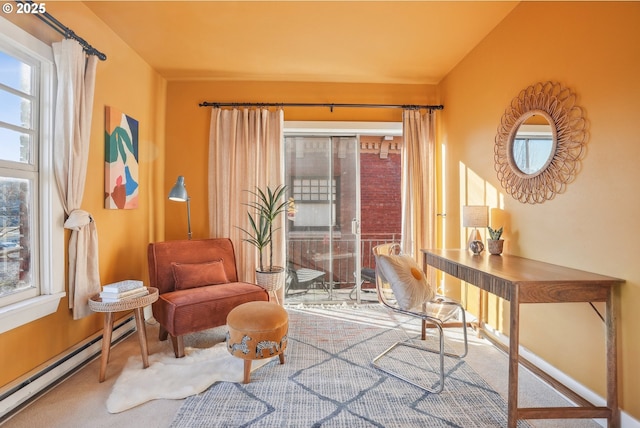 living area with carpet flooring and a baseboard heating unit